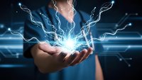 Businessman holding glowing electric lightning bolts in cupped hands against blue digital technology background for energy and power concepts.