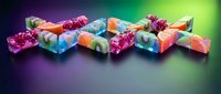 Colorful frozen fruit ice cubes with berries and citrus pieces on gradient background for summer drinks and cocktails.