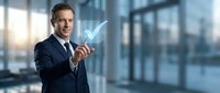 Professional businessman in dark suit holding glowing growth arrow chart in modern office environment with city skyline background for business success concepts.
