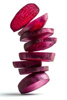 Fresh beetroot slices falling in dynamic motion isolated on white background for healthy cooking and nutrition concepts.