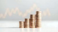 Stacks of gold coins arranged in ascending order showing financial growth with blurred stock market chart background, representing investment success.
