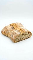Artisan sourdough bread loaf with rustic crust and airy crumb structure isolated on white background for bakery and food design projects.