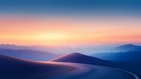 Winding mountain road curves through misty peaks at sunset, with layered purple and orange sky creating dreamy atmospheric landscape scenery.