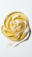 Swirled golden and white cosmetic gel or serum texture on white background, isolated for skincare product packaging and beauty design applications.