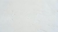 White textured surface with scratches and marks, suitable for backgrounds, overlays, and design projects requiring worn or distressed effects.