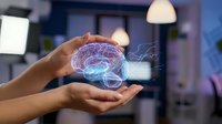 Hands holding glowing holographic brain with neural networks in modern office environment showcasing artificial intelligence and neuroscience technology concepts.