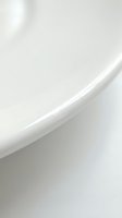 Minimalist white curved abstract form with soft shadows and highlights, creating elegant flowing lines against neutral background for modern design projects.