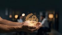 Hands holding glowing gear mechanism with sparks against dark background representing innovation, technology solutions and creative engineering concepts.