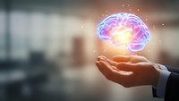 Businessman hand holding glowing brain with neural connections and light effects representing artificial intelligence, innovation and mental power concepts.