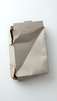 Crumpled cardboard packaging box with torn edges and folded surfaces isolated on white background for recycling and waste management concepts.