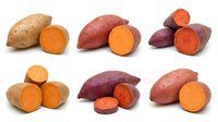 Assorted sweet potatoes and yams whole and sliced showing orange and purple flesh varieties for cooking, nutrition, and food styling projects.