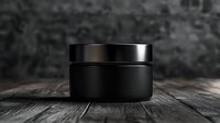 Black cosmetic jar on wooden surface against dark background, minimalist luxury skincare packaging mockup for beauty product presentation.
