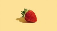 Fresh ripe strawberry with green leaves on yellow background. Healthy organic fruit isolated for food design, nutrition concepts and culinary projects.