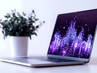 Modern laptop displaying purple sound wave visualization with sparkle effects on screen, potted plant in background creates minimal workspace setting.
