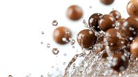 Chocolate candy balls splashing in water with dynamic droplets and bubbles creating dramatic motion effect on white background. Macro food photography.