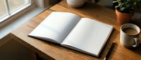 Open blank notebook on wooden desk with coffee cup and plant creating cozy workspace atmosphere for writing, journaling or planning activities.