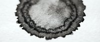 Metallic silver eyeshadow powder with dark charcoal edges in circular cosmetic pan, makeup artistry and beauty industry professional product closeup.