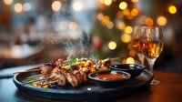 Grilled meat skewers with steaming hot sauce and white wine on dark plate against blurred warm bokeh lights background, restaurant atmosphere.