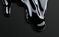 Glossy black liquid drips and flows creating abstract shapes against dark background, showcasing viscous texture with reflective highlights and smooth curves.