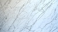 Elegant white marble texture with delicate gray veining creates natural pattern on polished stone surface, suitable for luxury interior design and architectural projects.