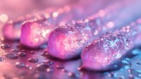 Frozen pink rose petals covered in ice crystals and water drops against blurred bokeh background in blue and purple colors create magical winter macro scene.