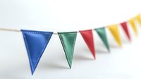 Colorful triangle bunting flags on white string, festive party decoration with blue, green, red and yellow pennants. Selective focus on front flags.