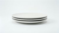 Stack of three clean ceramic dinner plates in white and gray tones on neutral background, suitable for tableware, kitchenware, and dining design projects.
