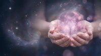 Hands holding glowing pink moon with cosmic galaxy and stars in background, representing spirituality, magic, and celestial wonder for mystical and fantasy concepts.