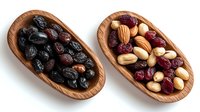 Healthy snack mix of dried cranberries, raisins, almonds, hazelnuts and macadamia nuts served in wooden oval bowls on white background, top view.