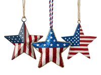 Patriotic star ornaments with flag design hanging from twine and rope, featuring red, white and blue colors. Perfect for holiday decorations, seasonal displays, and festive home decor.