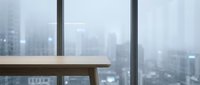 Modern office workspace with wooden desk and floor-to-ceiling windows overlooking blurred cityscape skyline. Corporate environment for business, work, and professional settings.