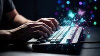 Hands typing on laptop keyboard with magical digital particles and colorful light effects emerging from screen in dark environment for creative projects.