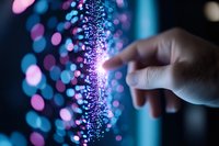 Hand touching glowing purple digital particles stream with bokeh lights background. Technology innovation and data visualization concept for business presentations.