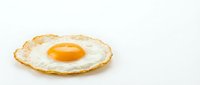 Fried egg with golden yolk isolated on white background for breakfast menu design and culinary projects.