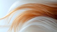 Flowing strands of white and ginger hair create gentle waves against light background, showcasing natural movement and soft texture for beauty and fashion designs.