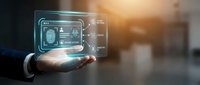 Businessman holding futuristic holographic interface with digital dashboard displaying data analytics and technology elements in modern office environment.