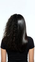 Woman showing hair transformation from frizzy curly to smooth straight brunette hair isolated on white background for beauty salon advertising.