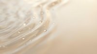 Gentle ocean wave washing onto sandy beach shore with soft foam and bubbles creating peaceful coastal scene for relaxation and summer vacation concepts.