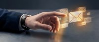 Male hand in business suit reaching toward glowing envelope icons on desk surface, representing email communication, digital messaging, and online correspondence for business contact.