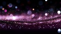 Pink and purple glowing particles with bokeh light effects on dark background create magical atmosphere for festive designs and holiday backgrounds.