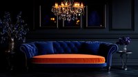 Luxurious navy blue velvet chesterfield sofa with orange cushion in dark moody interior featuring crystal chandelier and floral arrangements against black wall panels.