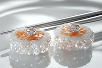 Elegant sushi rolls garnished with salmon and crystal-like decorative elements on reflective surface, modern gourmet presentation in soft lighting.
