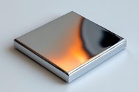 Metallic square platform with dynamic orange light reflection on polished chrome surface against white background, isolated design element for modern presentations.