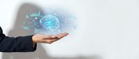 Businessman in dark suit holding glowing digital brain with data analytics icons, representing artificial intelligence, machine learning, and innovative technology solutions.