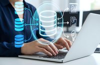 Business professional working on laptop with digital database management and cloud storage technology overlay icons for data analytics and information systems.
