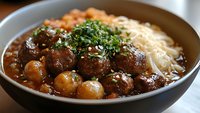 Hearty meatball stew with herbs and pasta in ceramic bowl. Comfort food dish with tender beef meatballs, rich gravy sauce and fresh parsley garnish.