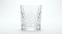 Empty crystal cut glass tumbler with diamond pattern isolated on white background for beverage service and bar accessories.