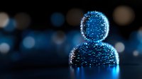 Glowing blue digital avatar silhouette made of light particles and dots against dark background with bokeh effects, representing artificial intelligence and digital identity.