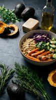 Healthy quinoa bowl with roasted vegetables, avocado and fresh herbs on dark slate background. Nutritious vegan meal with colorful ingredients and olive oil.