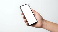 Hand holding modern smartphone with blank white screen mockup isolated on white background for app presentation and mobile interface design.